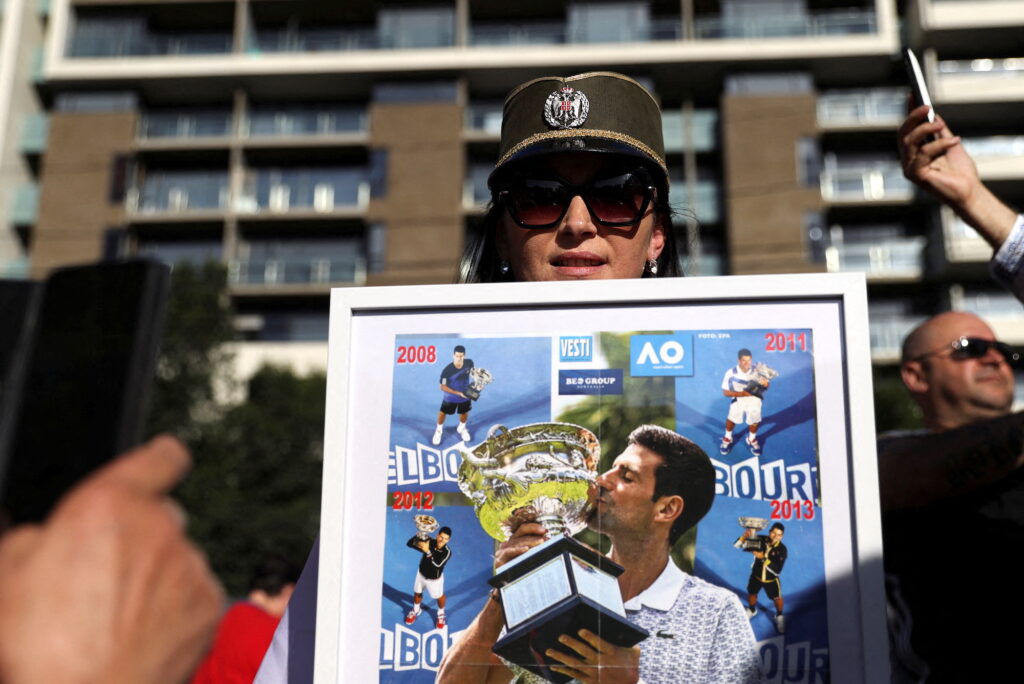 Supporters of Serbian tennis player Novak Djokovic rally outside the Park Hotel, where the star athlete is believed to be held while he stays in Melbourne, Australia