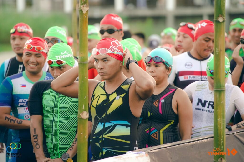 Standard category participants patiently waiting for their turn in the swim leg of the race